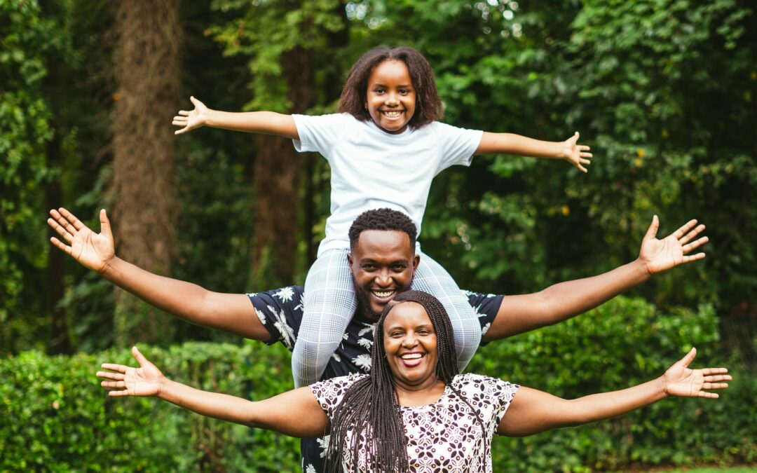 black mother, father, and daughter taking a picture